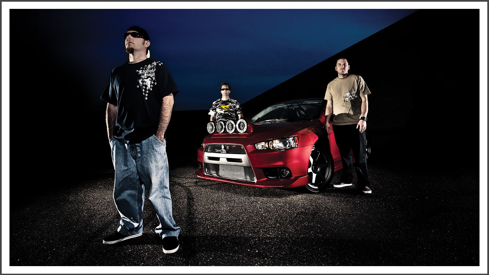 Lifestyle photograph of two men with a modified car at night