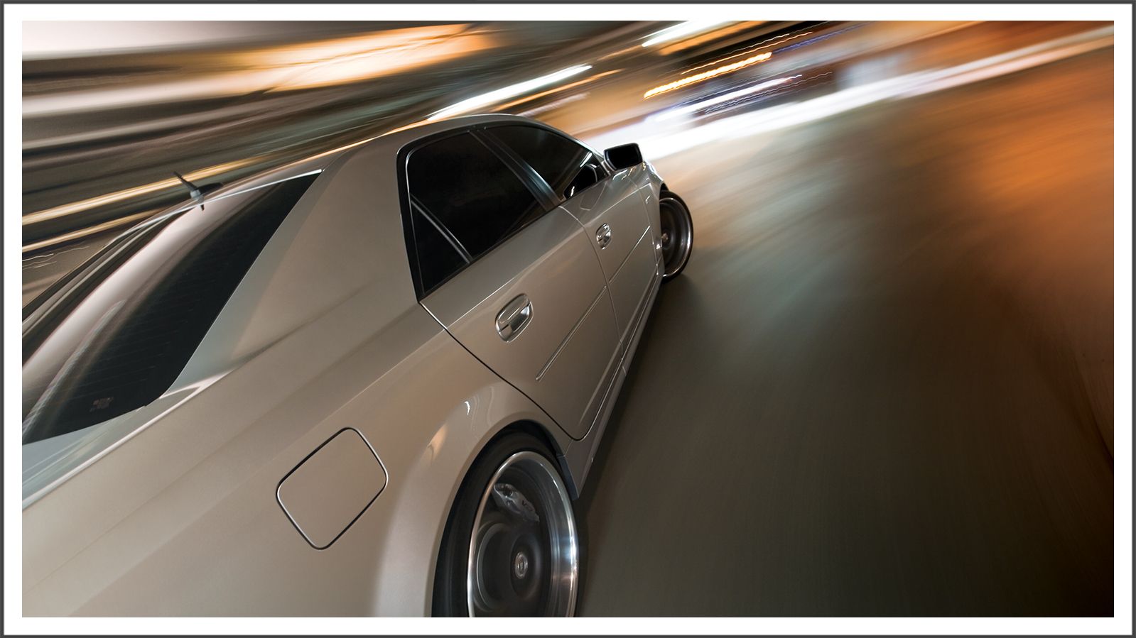 Motion-blurred rolling shot of a sports car